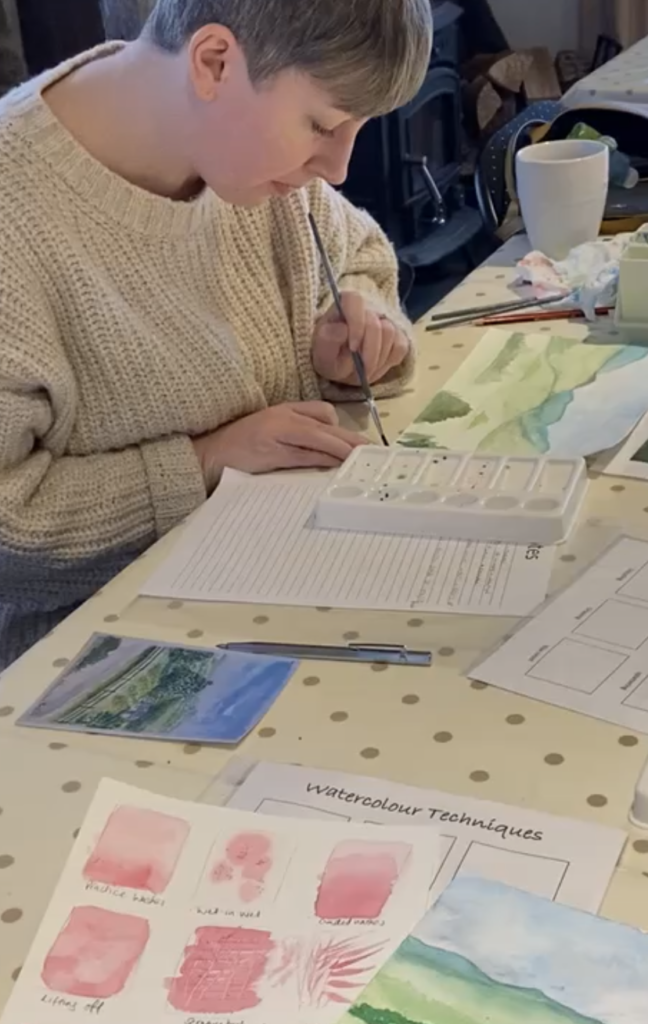 student completing watercolour painting