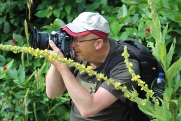 Beginner photographer taking a photo on a workshop.