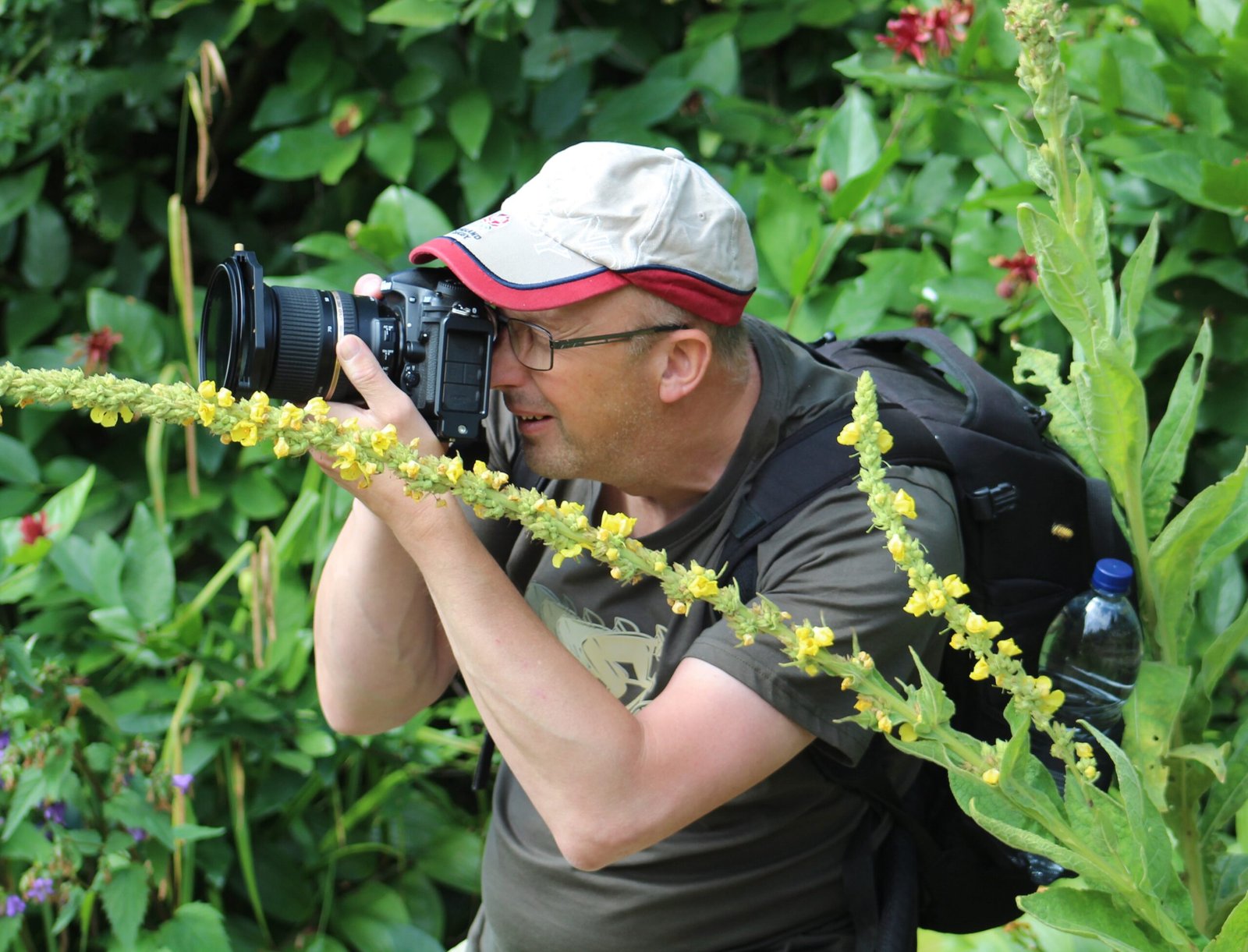 Beginner photographer taking a photo on a workshop.